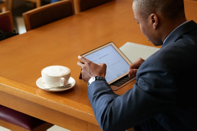 An illustration of a man workign on a tablet